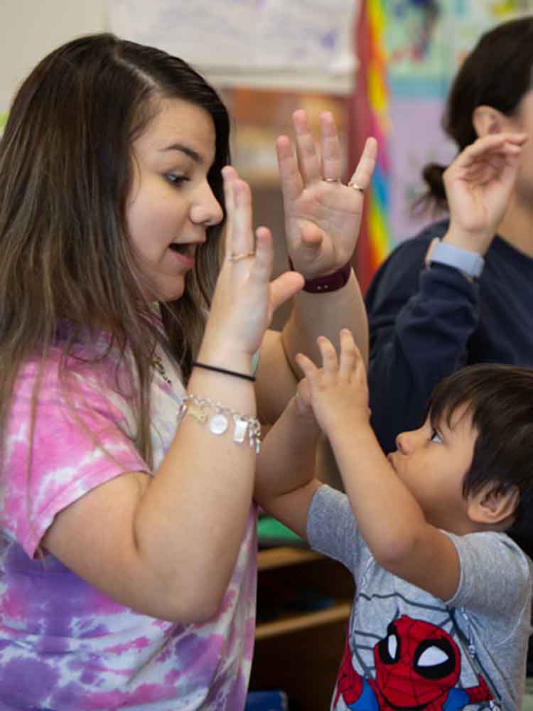 Child development student using developmentally appropriate teaching techniques